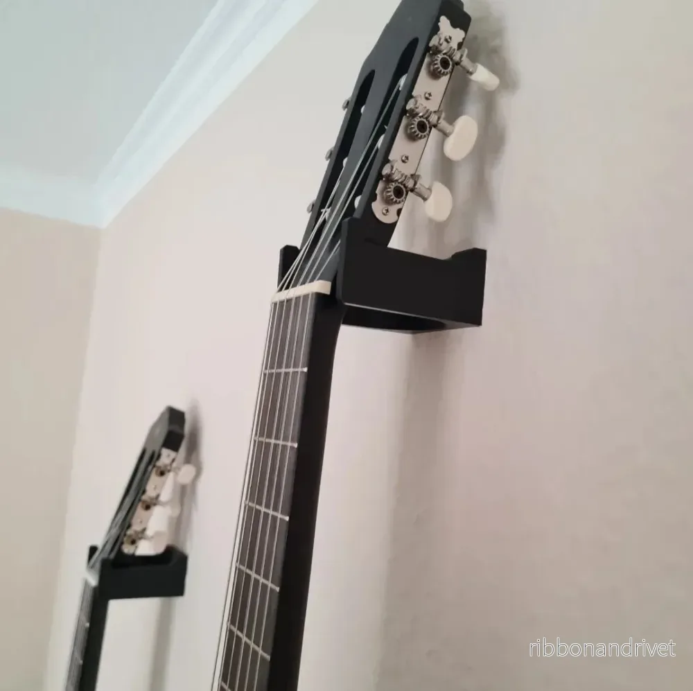 Stabil och diskret väggfäste för gitarr Stabil och diskret väggfäste för gitarr